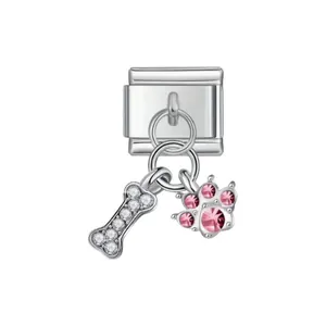 Detail of stainless steel modular link charm with crystal dog bone and pink paw pendant