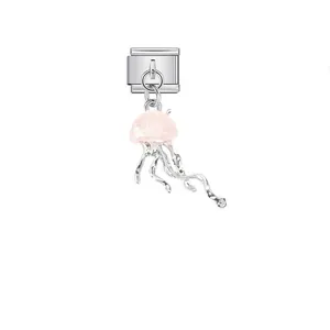 Detail view of a pink jellyfish charm on a stainless steel modular link for DIY jewelry.