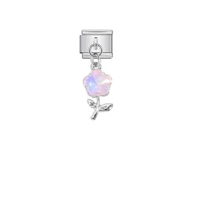 Close-up of pink iridescent flower charm on stainless steel Italian modular link link