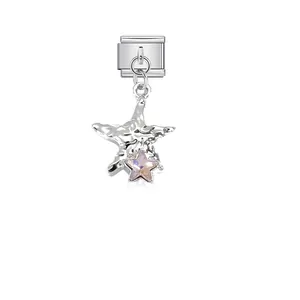 Detailed shot of a textured starfish charm with pink crystal on a stainless steel link