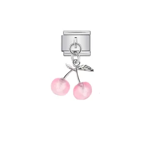 Detail view of a pink cherry modular charm link for customizable stainless steel bracelets