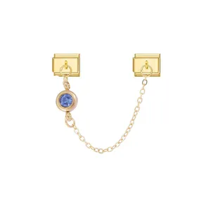 Detailed view of gold modular charm links with chain and blue gemstone for DIY bracelets