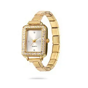 Close-up of elegant gold rectangular watch with rhinestone bezel and link bracelet