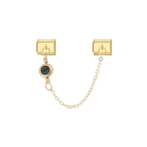 Detailed view of a gold modular bracelet link with a round green gemstone and chain.
