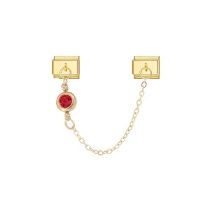 Detailed view of gold plated modular charm featuring a red zircon pendant and link chain