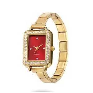 Macro detail of elegant rectangular gold watch featuring a red dial and crystal bezel