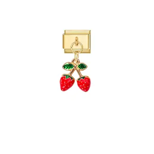 Detailed view of a gold Italian charm link featuring a red cherry dangle pendant
