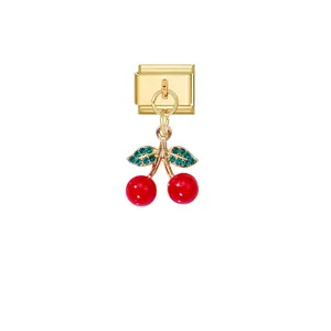 Detailed view of a vibrant red cherry charm with green crystals on a gold modular bracelet link.