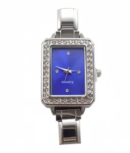 Close-up of rectangular blue dial watch featuring a rhinestone-studded silver bezel