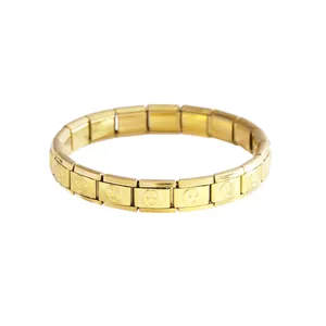 Detail shot of a gold-plated stainless steel Italian modular charm bracelet with smiley faces.