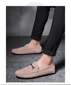 Detailed view of premium men's tan suede loafers with elegant metal bit decoration