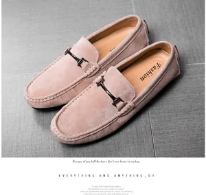 Detailed macro view of tan suede men's driving loafers with metallic bit strap detail