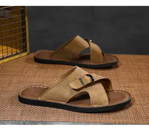 Detailed close-up of men's casual brown leather slides featuring a stylish black buckle