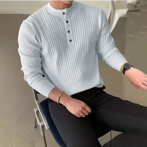 Detailed view of men's rib-knit henley sweater with mock neck and button placket