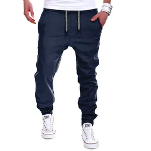 Detailed view of men's navy blue casual drop-crotch joggers with elastic cuffs and drawstring.