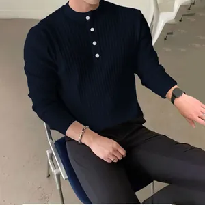 Detail of navy blue ribbed knit sweater with buttoned half-neck collar for men.