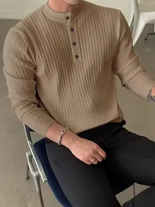 Detail view of a men's beige ribbed knit Henley sweater featuring a stylish button-down collar