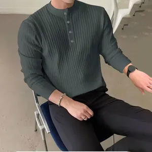 Close-up of men's dark green long-sleeved knitted henley sweater with button detail