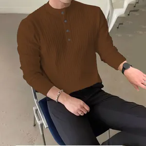 Detailed view of a men's brown long-sleeve knit sweater featuring a buttoned half-high collar