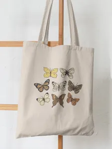 Detail shot of cream canvas tote bag featuring nine colorful watercolor butterfly prints