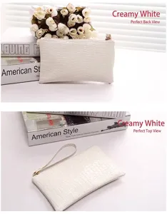 Close-up of white crocodile pattern clutch bag with wrist strap and zipper