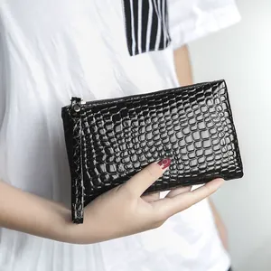 Stylish black crocodile embossed clutch bag for women featuring a practical wristlet strap