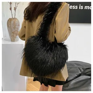 Black faux fur heart-shaped shoulder bag in Y2K style worn with a khaki blazer.