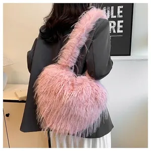Heart-shaped pink faux fur shoulder bag with long fringe tassels and millennium style.