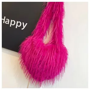 Detailed view of vibrant pink heart-shaped faux fur bag with long shaggy fringe