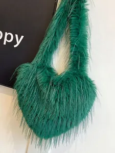 Vibrant emerald green heart-shaped faux fur shoulder bag with long Y2K style fringes