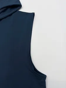 Detailed view of reinforced armhole stitching on a navy blue hooded sports vest
