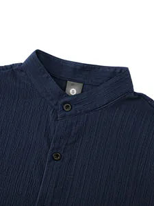 Close-up of navy blue men's casual shirt with mandarin collar and crinkle texture