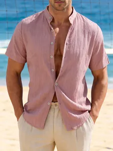 Detailed view of pink textured short-sleeved linen shirt for men on beach background