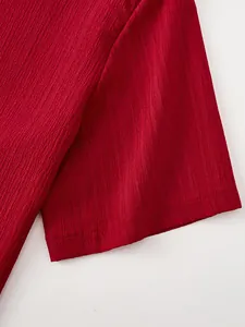 Macro view showing the crinkle texture and stitching on the red short sleeve shirt