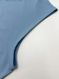 Close-up of durable flatlock stitching on blue men's quick-dry athletic sleeveless vest.