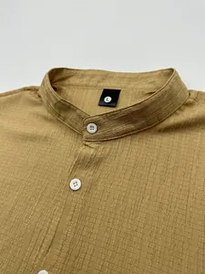 Detail of mustard yellow men's casual shirt with mandarin collar and white buttons