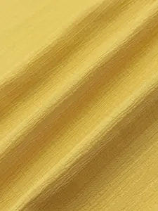 Close-up detail of yellow seersucker fabric texture for high-quality men's casual shirt