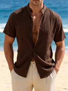 Close-up detail of brown short-sleeved casual shirt with textured fabric for men at beach.