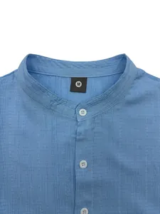 Close-up of men's light blue casual shirt featuring a band collar and textured fabric.