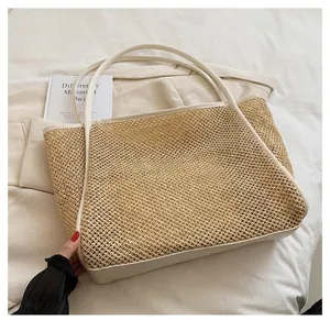 Nahaufnahme einer großen Strohtragetasche mit elegantem weißem Lederbesatz
