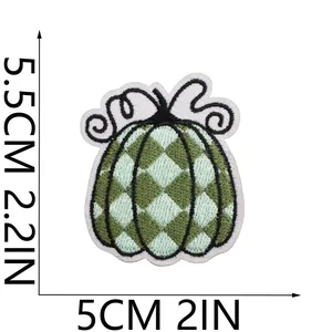 Detail view showing 5.5x5cm size of the green checkered pumpkin embroidered patch