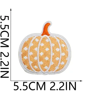 Macro detail of a 5.5cm pumpkin embroidery patch featuring an orange lattice design