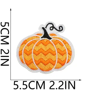 Macro view of festive Halloween pumpkin embroidery patch with dimensions in cm and inches