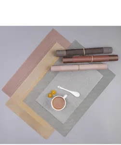 Detailed close-up view of various PVC woven placemats in elegant neutral textures