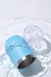 Detail view of a blue mini stainless steel insulated cup submerged in water for rinsing