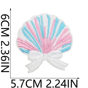 Shell embroidered patch in pink and blue with a white bow for clothing decor