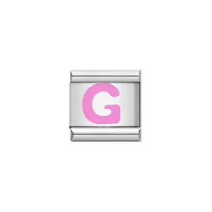 A detailed macro view of a silver Italian charm bracelet link with a pink letter G