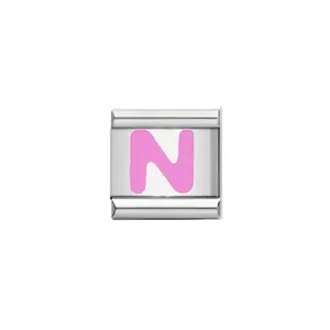 Close-up detail of a pink enameled letter N Italian charm link for DIY charm bracelet