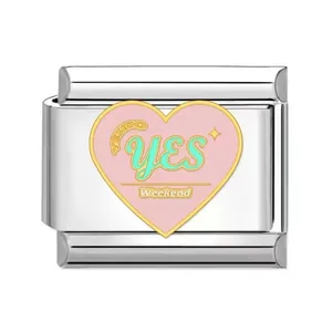 Detailed view of pink heart enamel charm with YES Weekend text on stainless steel base