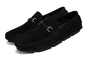 Detail view of men's black suede loafers with elegant metal bit and rubber sole.